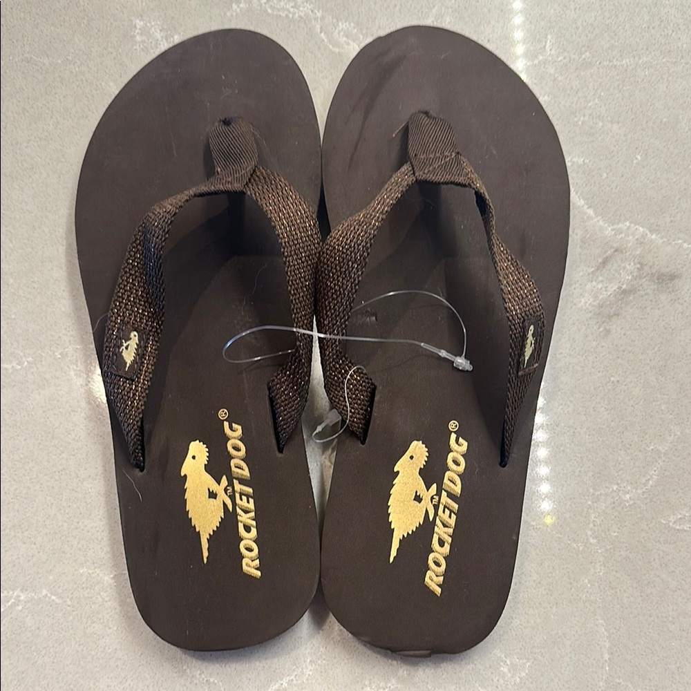 Brand new Rocket Dog brown flip flops. Size 7